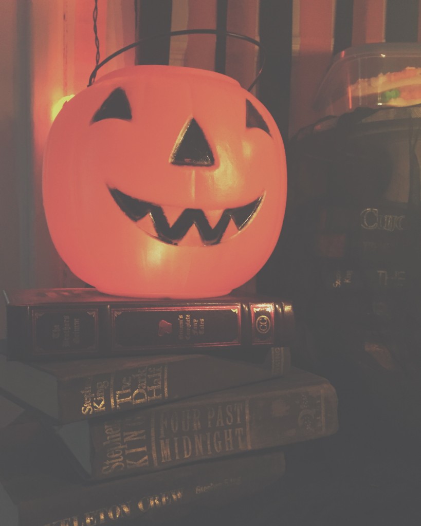 Pumpkin light on stack of old books