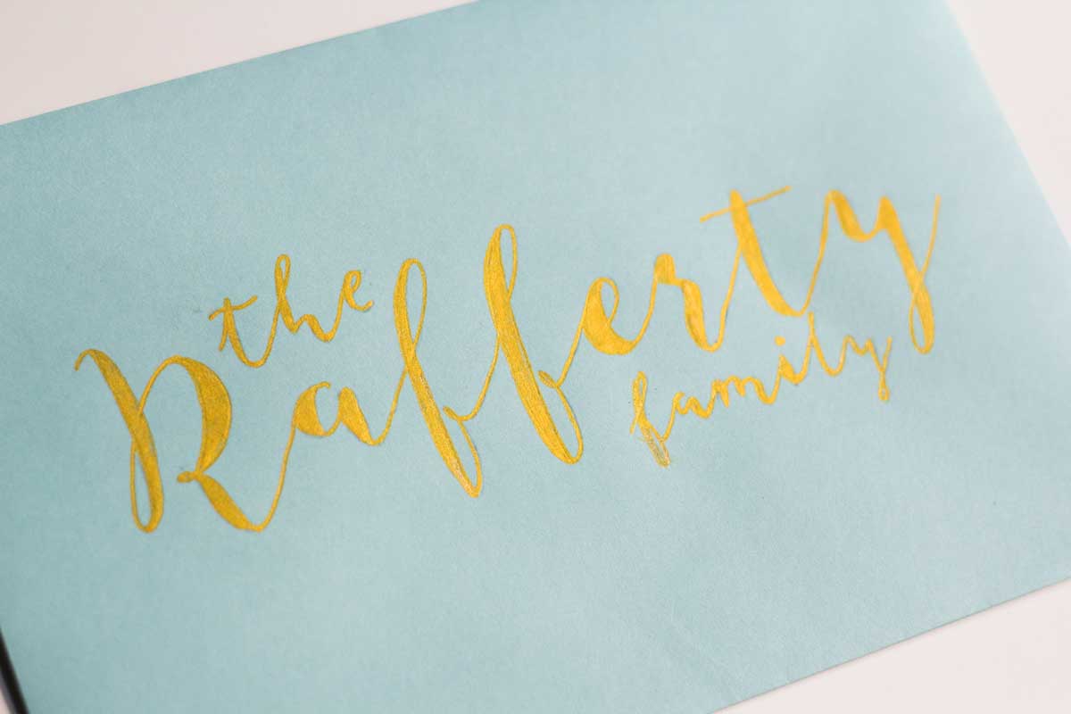 Using metallic paint pens for amazing DIY faux hand lettered envelopes