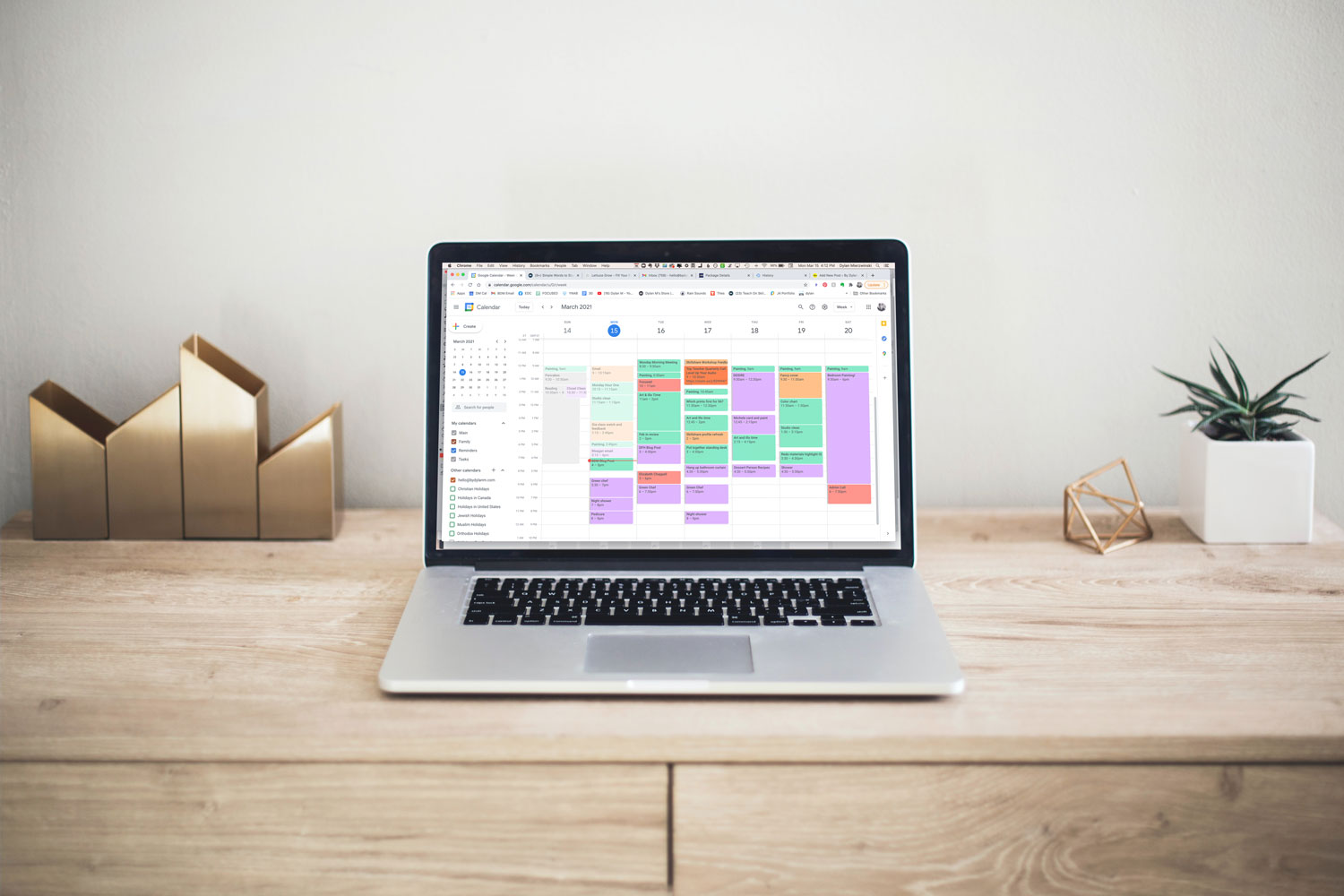 open laptop on desk with full week of google calendar schedule visible
